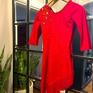 Red figure skating dress with gold embellishments. With tassel angel bottom.